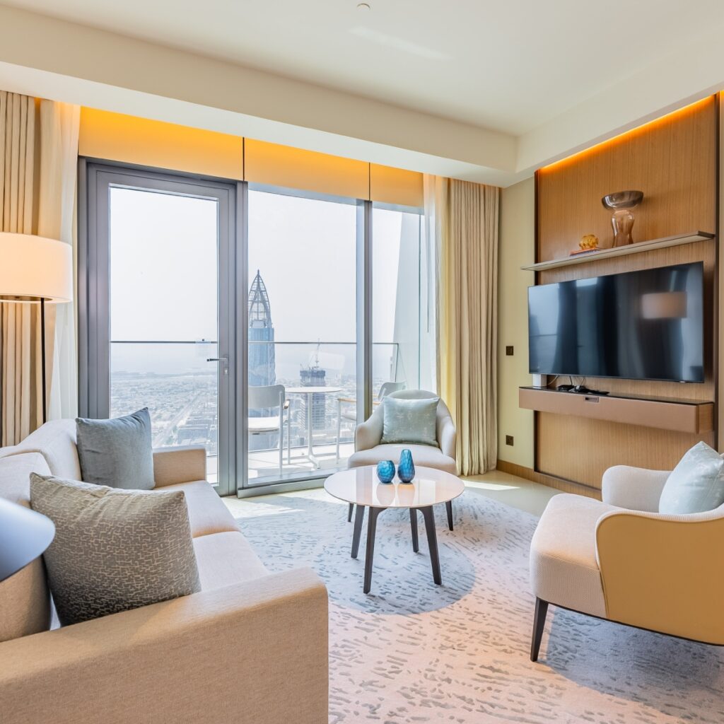 Living room in a Monty apartment, with floor-to-ceiling windows and a city view