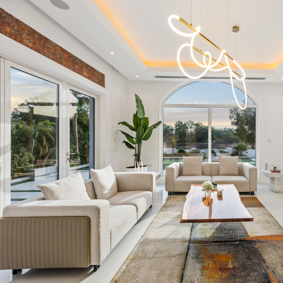 Bright living room in a Monty apartment with cream sofas